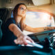 Woman in semi-truck cab.