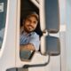 Man in semi-truck leaning out the window.