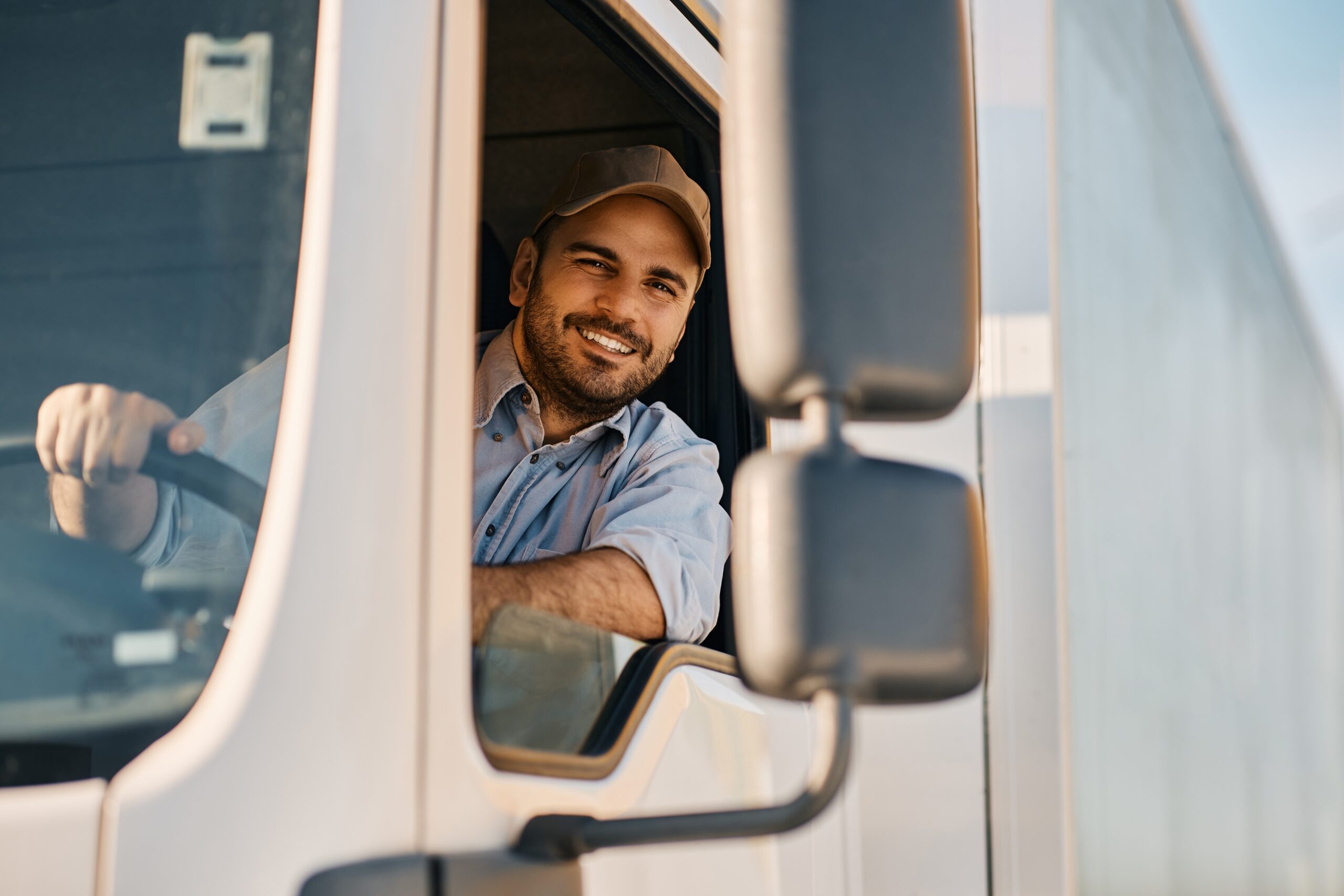 Man in semi-truck leaning out the window.