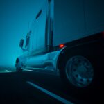 Semi-truck on the road, at night.