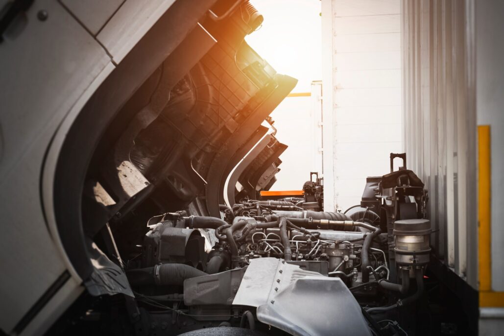 Truck with open hood ready for engine inspection at sunset.