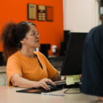 Employee assisting a customer at a service desk