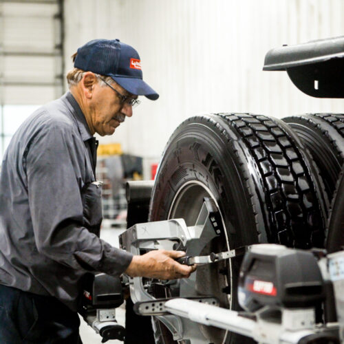 alignment 1 Technician servicing truck tires in a garage